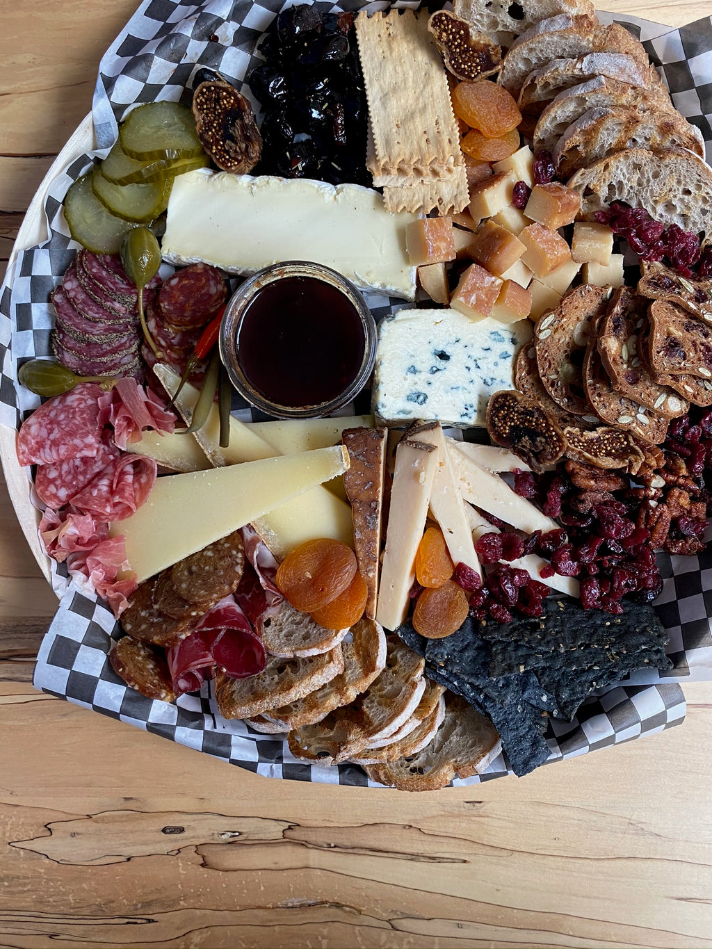 cheese and charcuterie board with assorted cheeses, breads and meats. 