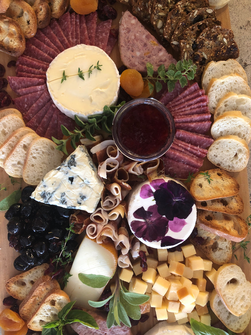 cheese and charcuterie board with assorted cheeses, breads and meats. 