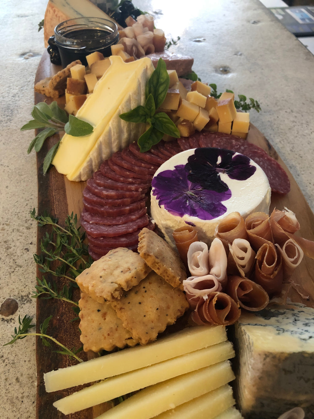 cheese and charcuterie board with assorted cheeses, breads and meats. 